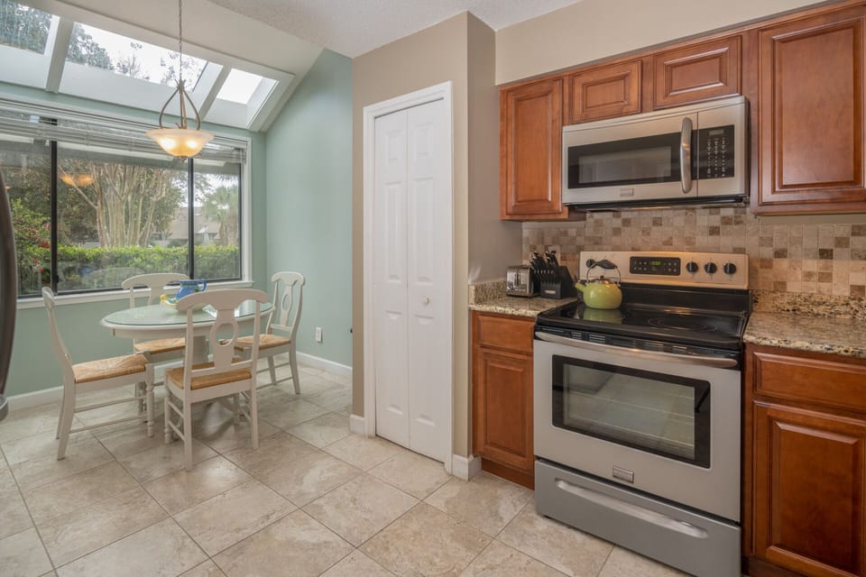 The kitchen and dining area offer a bright, functional layout designed for everyday living and easy entertaining.