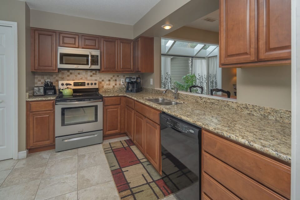 This open kitchen and with pass thru window create an easy, welcoming hub for everyday living and entertaining.