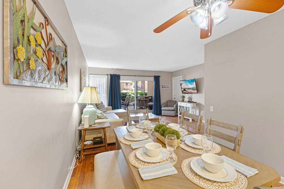 The dining area flows seamlessly into the comfortable living space, creating an open setting for shared meals and relaxing evenings.