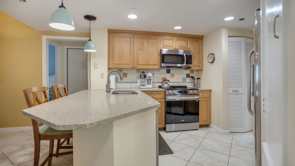 This open kitchen and breakfast bar create an easy, welcoming hub for everyday living and entertaining.