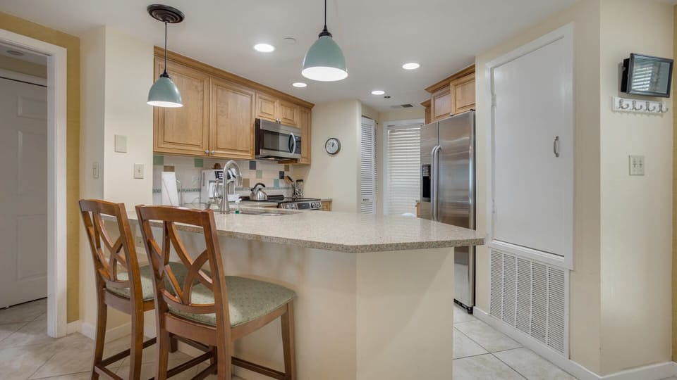 This inviting kitchen features a spacious breakfast bar with seating, perfect for casual meals or entertaining.