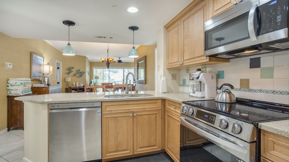 Ample counter space, and a functional layout make meal prep effortless, while the raised bar offers casual seating for morning coffee or quick bites.