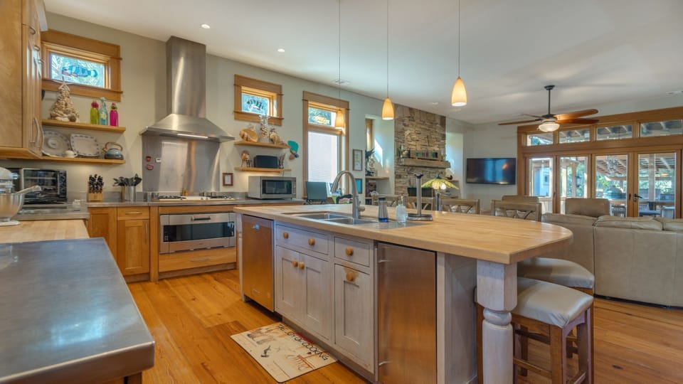 Well-appointed kitchen with open layout that seamlessly connects to a comfortable living area