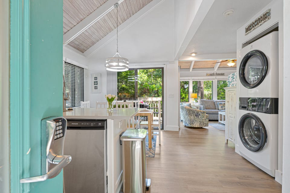 Natural light pours in through expansive windows, creating a warm, inviting atmosphere from the moment you arrive.