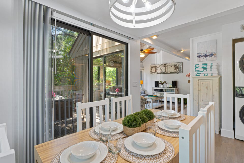 Comfortably seating four, this inviting space is surrounded by natural light and sits just steps from both the kitchen and living room, creating an easy flow for entertaining.