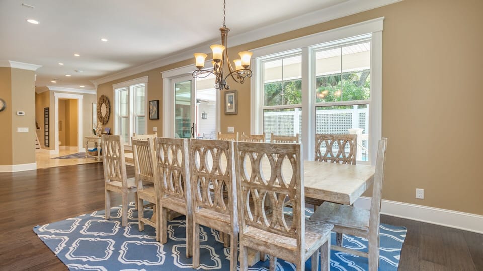 This expansive open-concept living area brings everyone together with ease. A large dining table anchors the space for family meals.