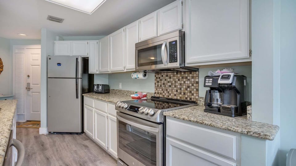 Stainless steel appliances  add a polished touch, while the open layout keeps the kitchen connected to the rest of the living space