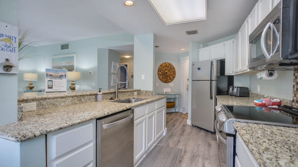 This inviting kitchen features a spacious breakfast bar with seating, perfect for casual meals or entertaining.