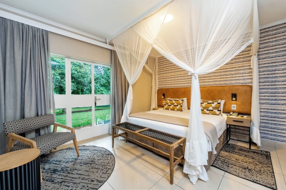 Deluxe Room, Multiple Beds, Garden View | In-room safe, desk, laptop workspace, blackout drapes