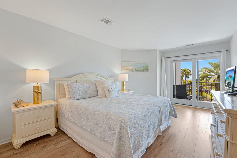 Sliding glass doors lead to a private balcony, creating an inviting spot to enjoy morning light or quiet evenings surrounded by the Ocean view.