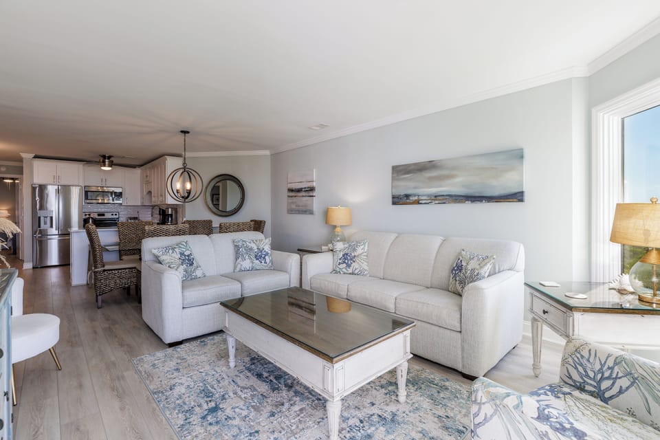The layout flows effortlessly into the dining area and renovated kitchen, making this the perfect gathering spot for family and friends.