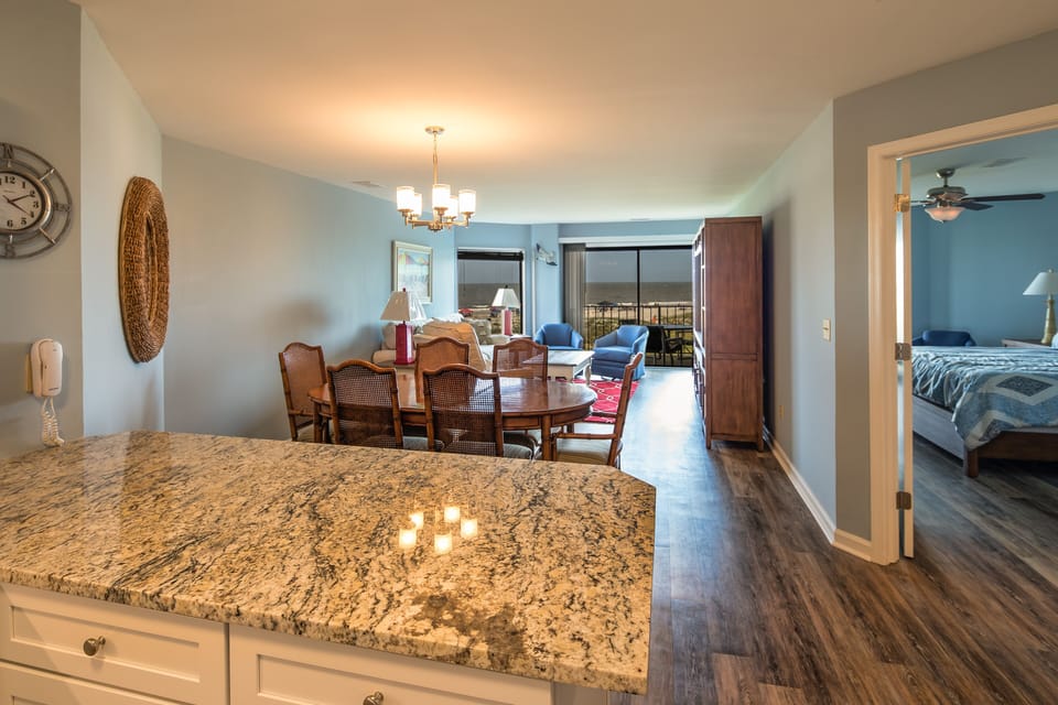 This bright dining area seamlessly connects to the living room, creating an open and inviting space for gathering after a day at the beach.