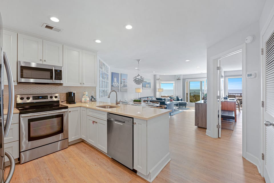 Stainless steel appliances add a polished touch, while the open layout keeps the kitchen connected to the rest of the living space