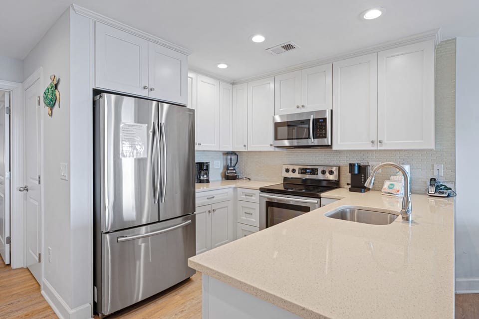This bright, functional kitchen offers ample cabinet storage, a full suite of appliances and a generous peninsula that expands your prep space.