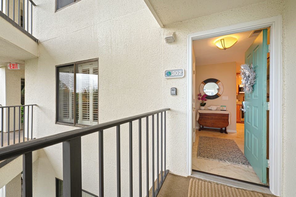 The open-air walkway keeps the space bright and breezy, while the unit's position limits foot traffic—creating a quieter arrival experience for guests.