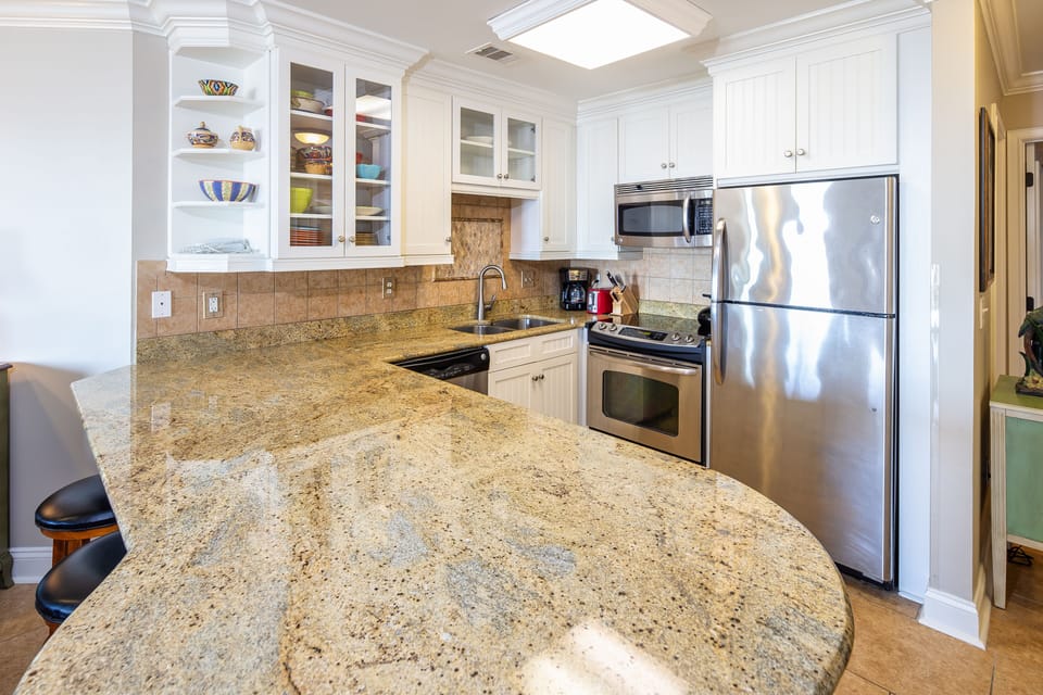 This bright, functional kitchen offers ample cabinet storage, a full suite of appliances and a generous peninsula that expands your prep space.