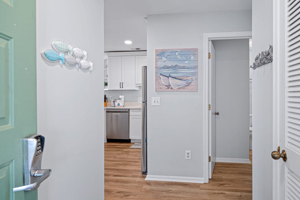 Just beyond the front door, you'll find an updated kitchen with crisp white cabinetry and stainless appliances.