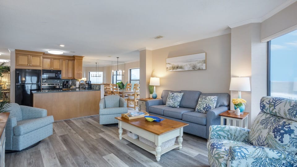 Area is arranged for easy conversation and movie nights, while the open staircase adds architectural interest without interrupting the sightlines.