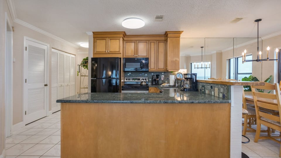Soft coastal tones create a bright, inviting atmosphere, while generous counter space makes meal prep easy.