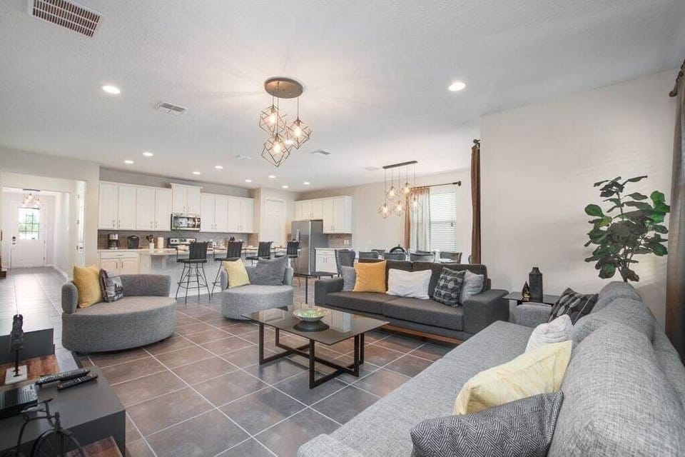 Wide view of elegant living, dining and kitchen areas
