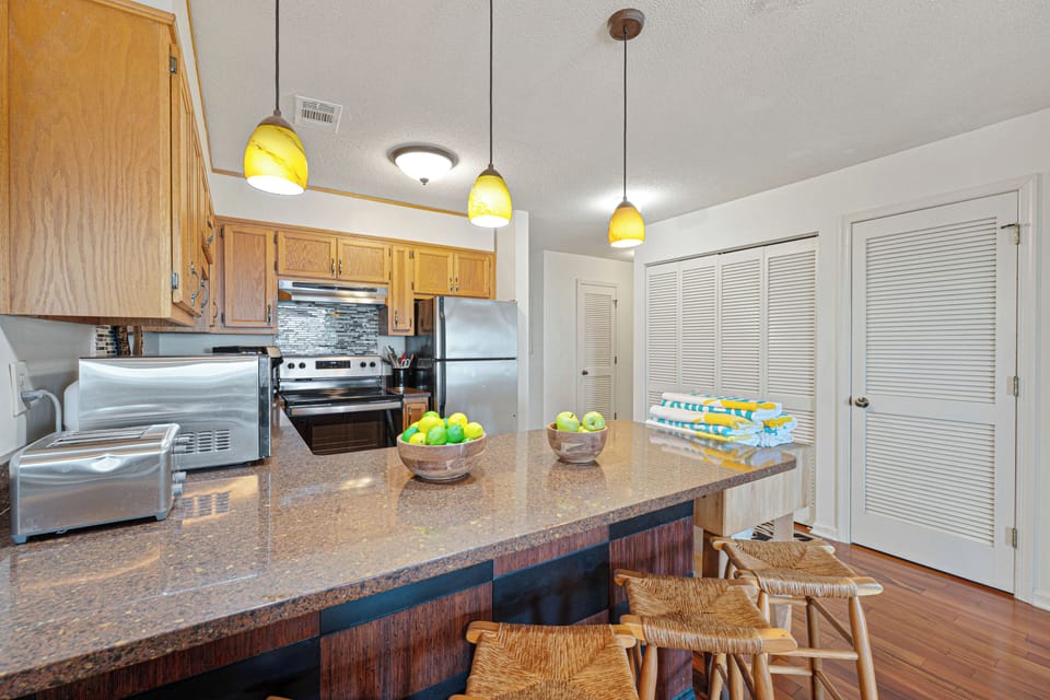 Additional seating at the breakfast bar provides the perfect spot for casual meals, snacks, or morning coffee while planning the day's adventures.