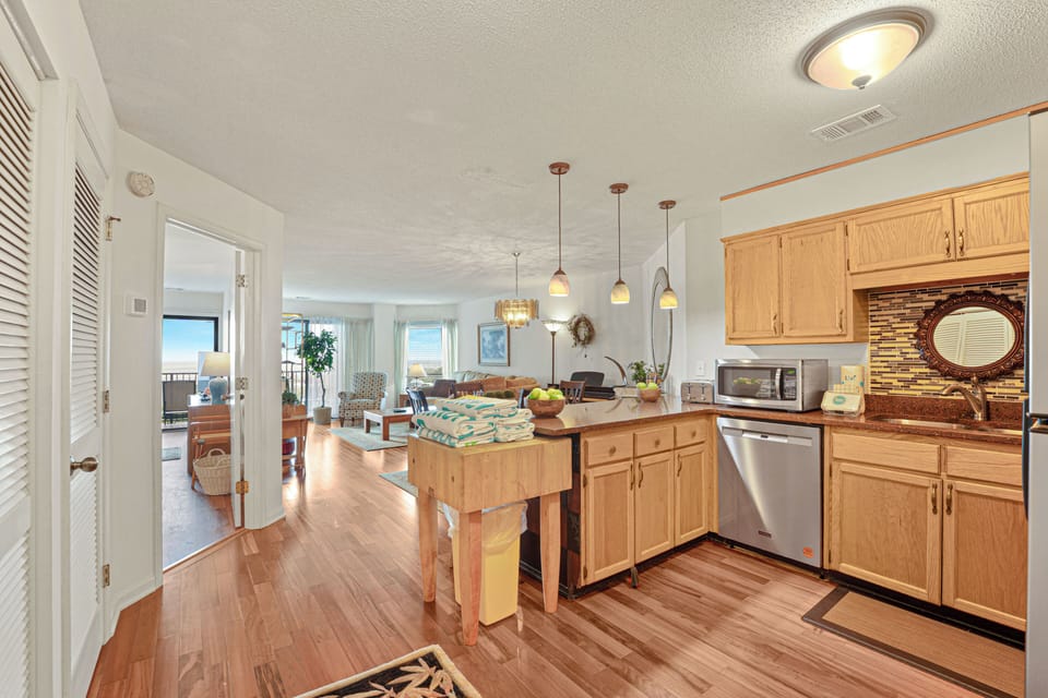 The open-concept kitchen flows effortlessly into the dining and living areas, creating a bright, welcoming space where everyone can gather.