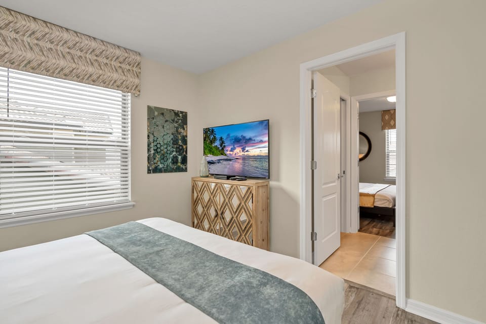 View 2 of luxurious queen bed with flat screen TV