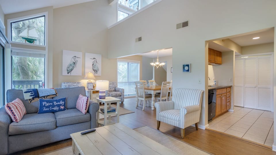 This open, light-filled living space welcomes you with soaring ceilings and a relaxed coastal vibe.
