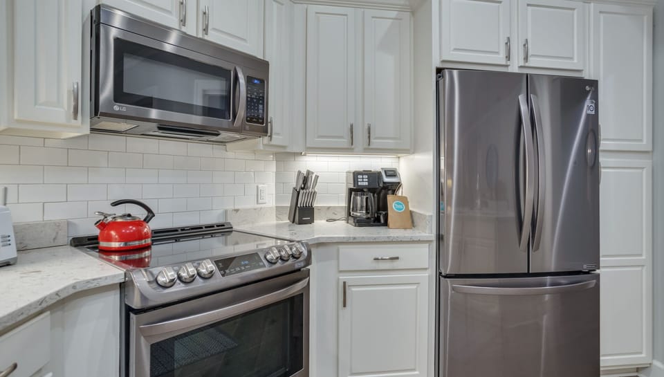 Stainless steel appliances add a polished touch, while the open layout keeps the kitchen connected to the rest of the living space