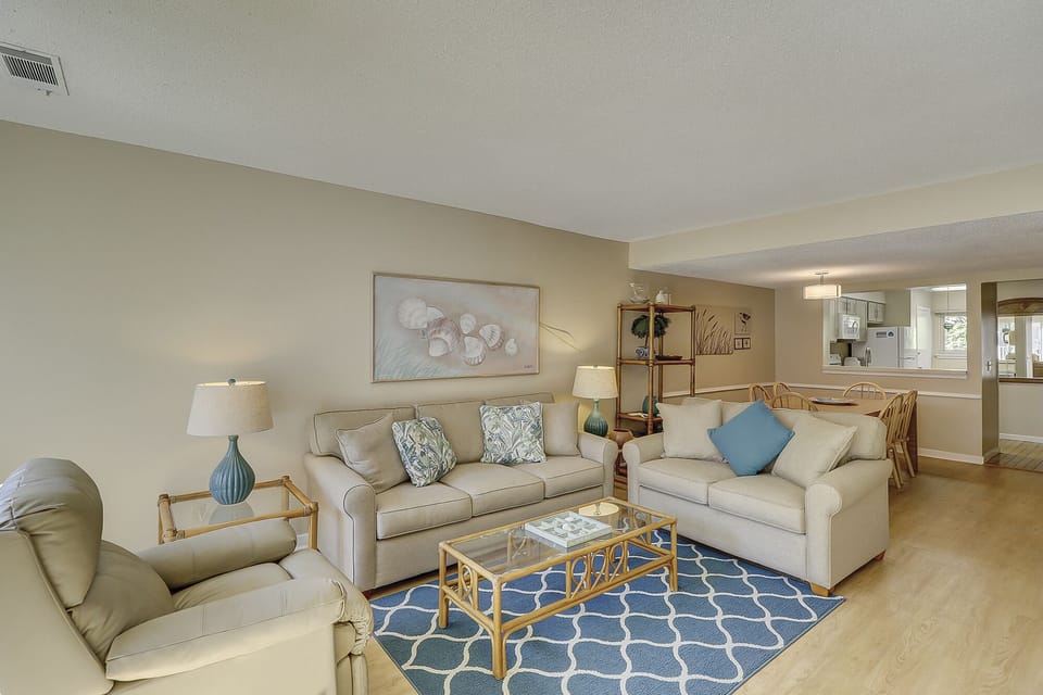 This bright, open living and dining area is designed for comfort and easy coastal living.