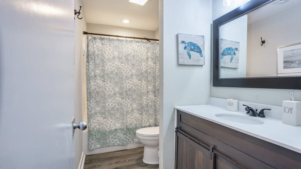 This bathroom is clean, bright, and thoughtfully updated with a modern vanity and a full tub-and-shower combo