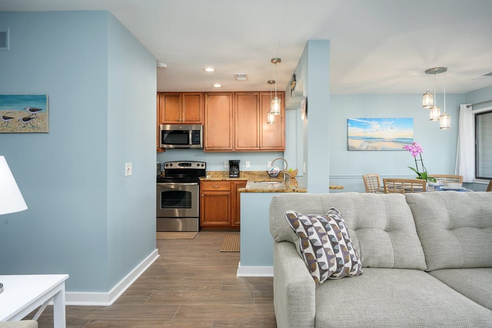 Well-designed open layout with an updated kitchen, breakfast bar, and adjacent dining and living areas—perfect for easy entertaining, shared meals, and relaxed island living.