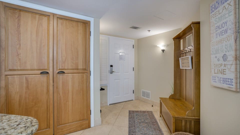 A welcoming entry sets the tone as you step inside, featuring a tiled foyer with soft coastal colors and classic finishes.