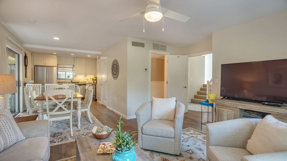 It opens seamlessly to the dining area and kitchen, creating a welcoming layout ideal for gathering, relaxing, and entertaining.