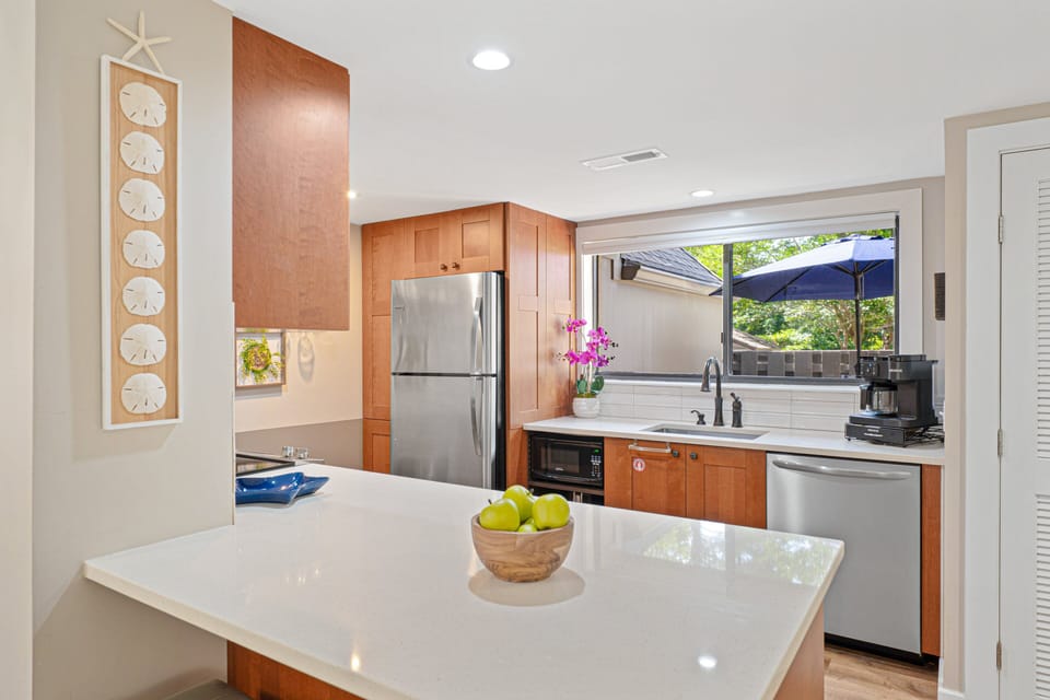 The well-equipped kitchen offers generous counter space, ample storage, and an open connection to the dining and living areas,