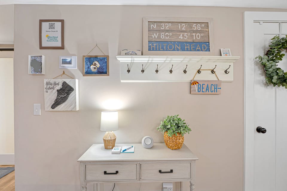 This charming entry area features island-inspired décor, convenient storage hooks for beach bags and towels, and a dedicated welcome station.