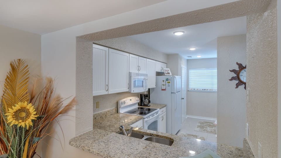 Open concept kitchen with white appliances
