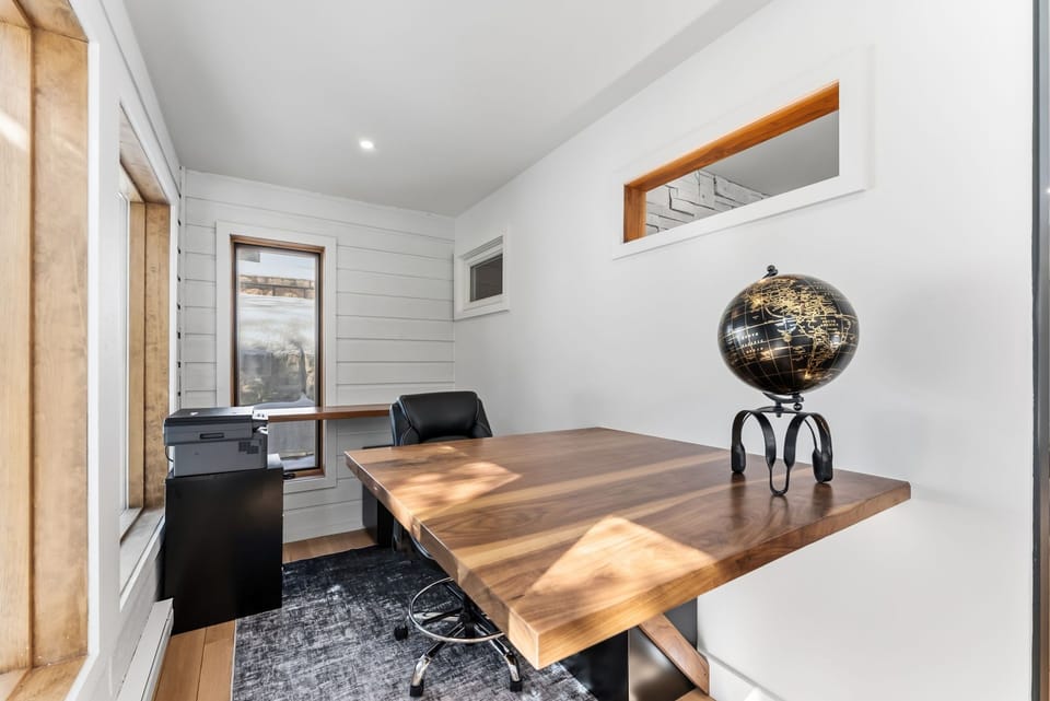 Your dedicated workspace features a stunning live-edge walnut desk where you can tackle projects while enjoying natural light streaming through the window.