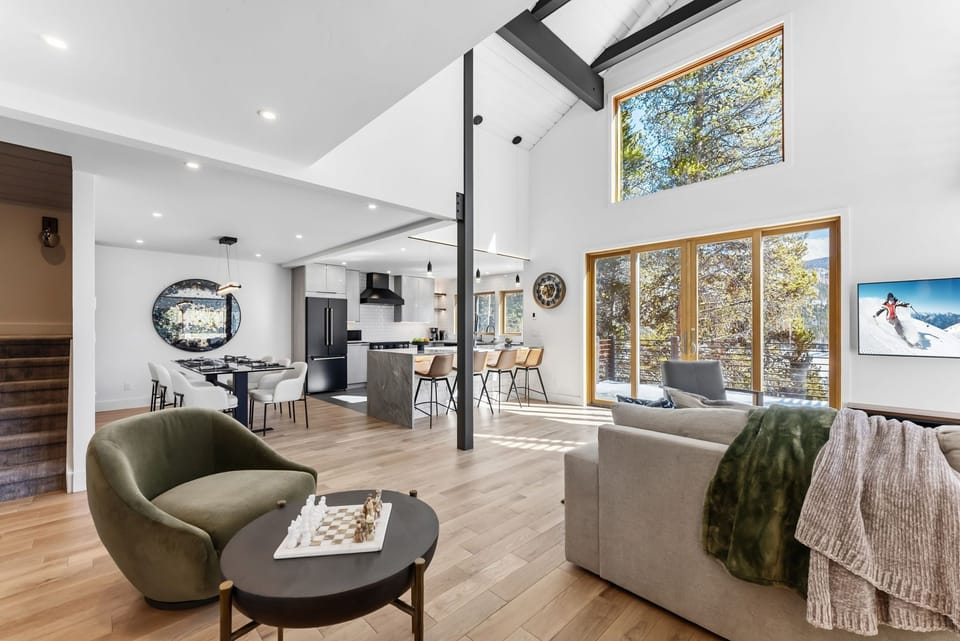Relax in this stunning open-concept living space where natural light streams through floor-to-ceiling windows, creating the perfect mountain retreat atmosphere.