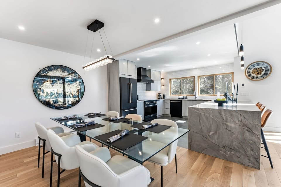 Your elegant dining space flows seamlessly into a chef-quality kitchen with marble island, perfect for memorable meals together.