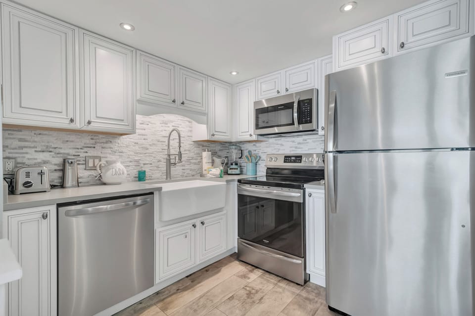 Fully Equipped Upgraded Kitchen with Quartz Countertops and Stainless Steel Appliances