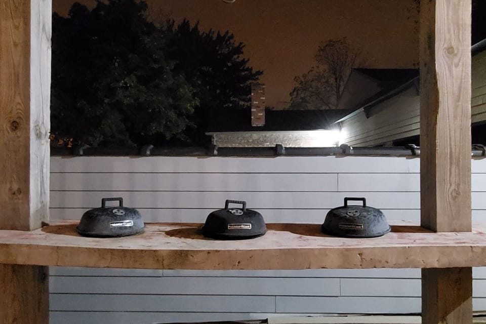 Patio area with 3 built-in charcoal BBQ grills. 