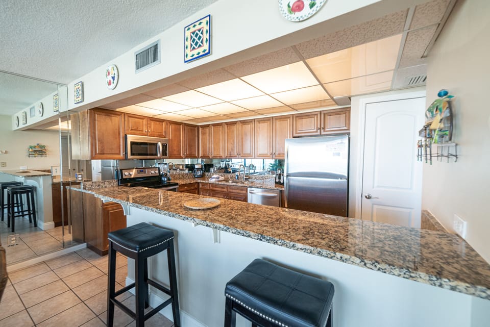 Well equipped gourmet kitchen with an ocean view, granite counter tops, and updated appliances