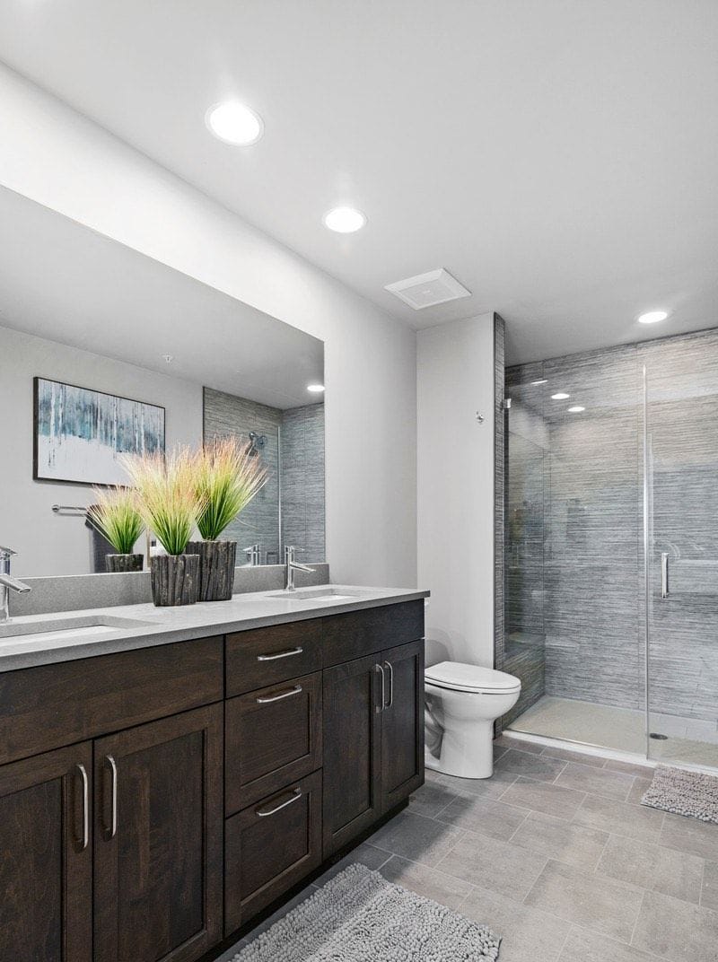Master Bathroom has double vanity and standing shower w/bench and glass doors
