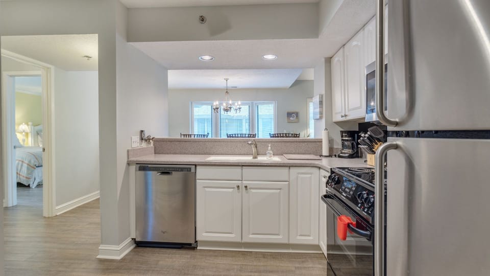 The layout is designed for easy entertaining, with an extended counter and breakfast bar opening to the main living area.