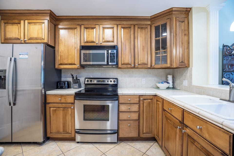 Thoughtful details like crown molding, ample prep space, and convenient access to adjacent dining and living areas make this kitchen both inviting and highly practical