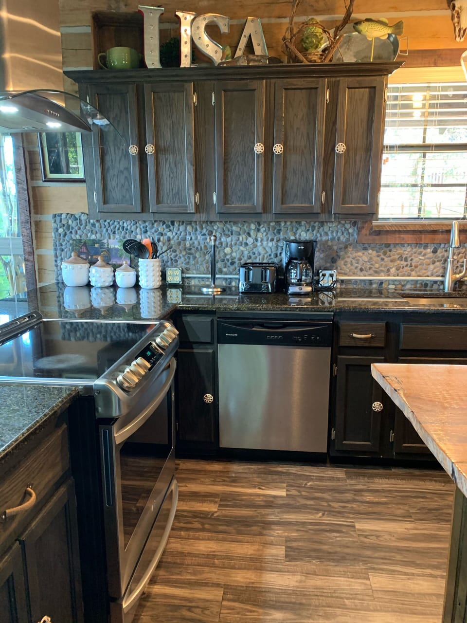 View of stove and dishwasher in kitchen. 