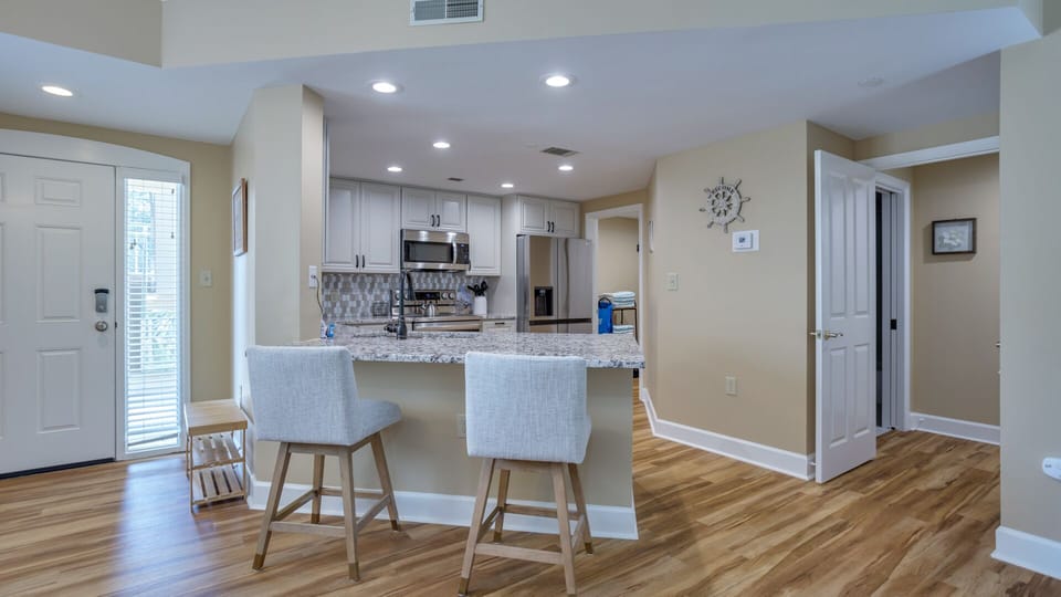 This open kitchen and breakfast bar create an easy, welcoming hub for everyday living and entertaining.