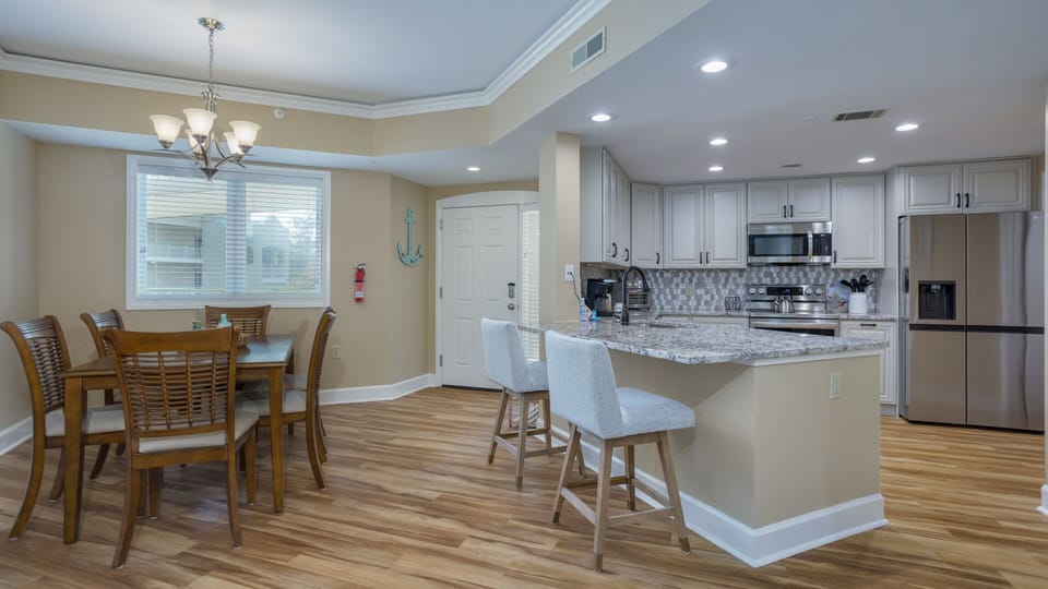 This bright, functional kitchen offers ample cabinet storage, a full suite of appliances and a generous bar that expands your seating.