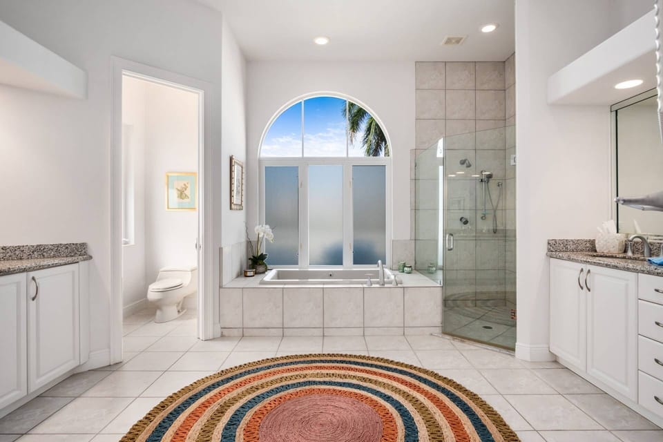 The master bathroom features dual vanities, separate water closet, soaker tub and walk-in shower.